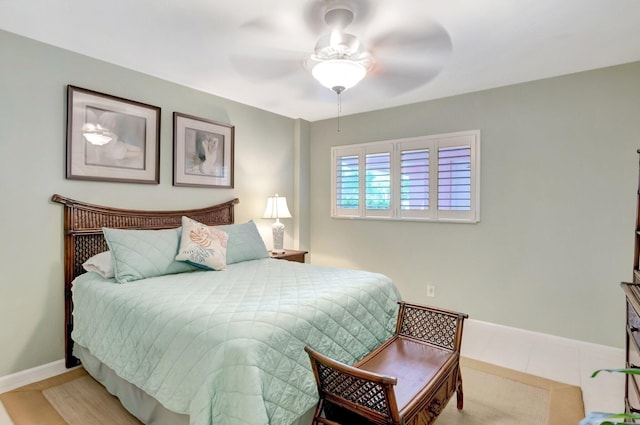 bedroom featuring baseboards, ceiling fan, and tile patterned flooring