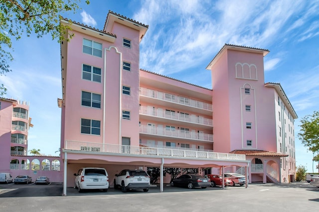 view of building exterior with covered parking