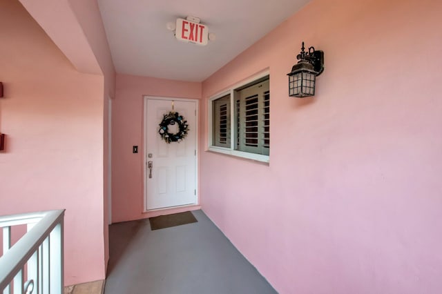 property entrance with stucco siding