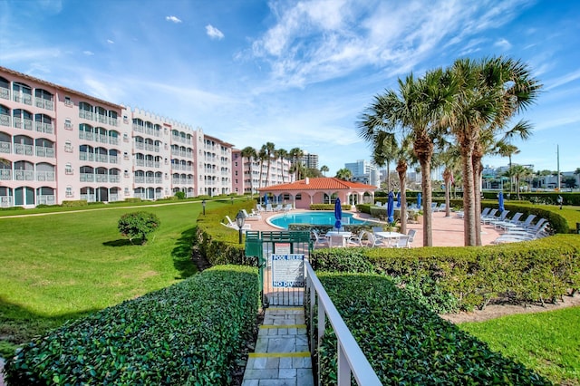 view of community featuring a yard and a pool