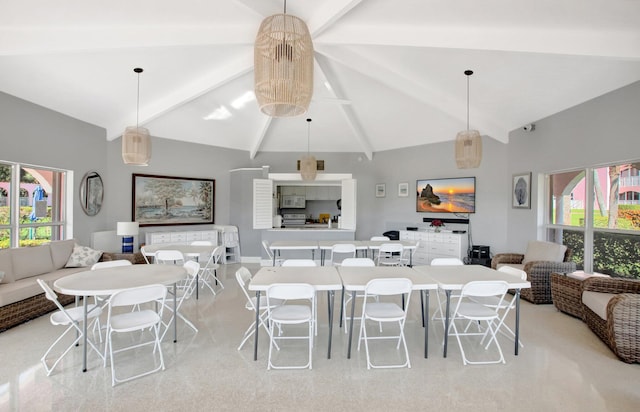 dining room featuring beam ceiling and high vaulted ceiling