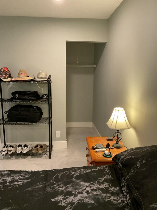 bedroom with baseboards, marble finish floor, and ceiling fan