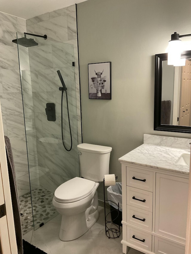 bathroom featuring toilet, marble finish floor, vanity, and a walk in shower