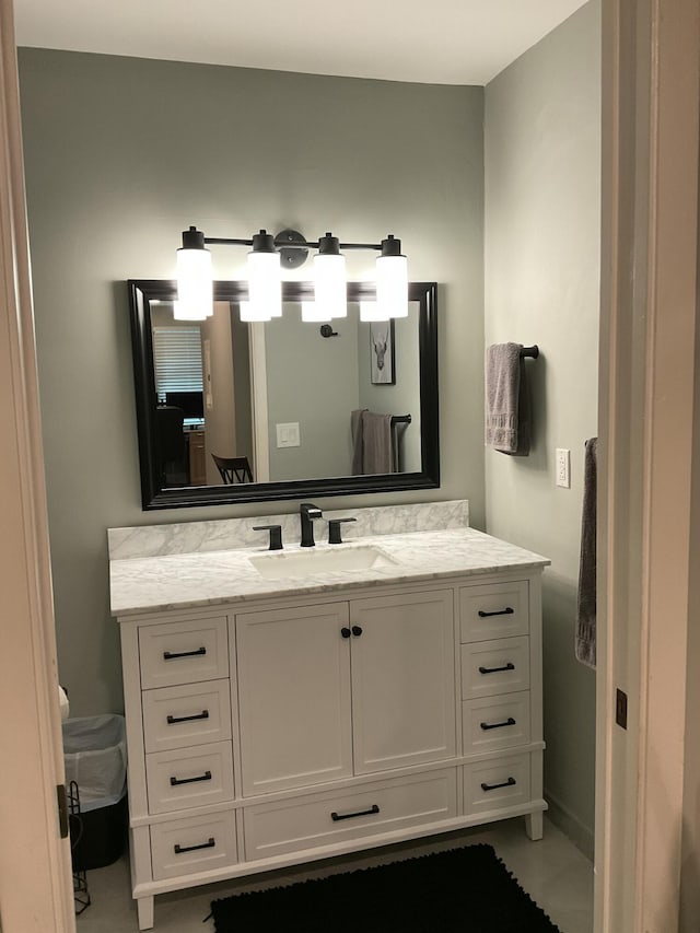 bathroom with baseboards and vanity