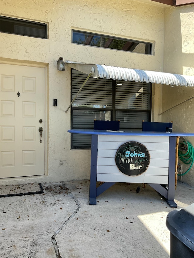 entrance to property with stucco siding