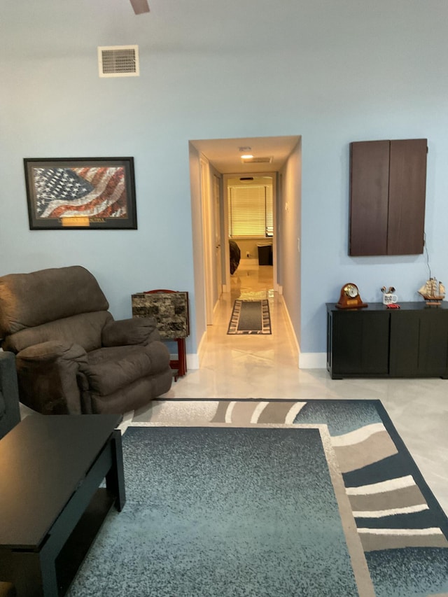 living room featuring baseboards and visible vents