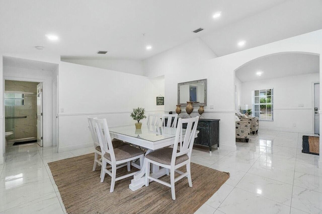 dining room featuring arched walkways, visible vents, marble finish floor, and baseboards