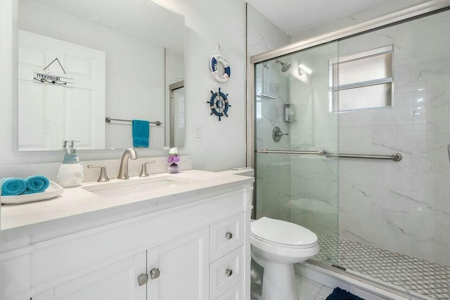 bathroom with a marble finish shower, toilet, and vanity