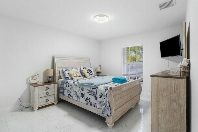 bedroom with visible vents, marble finish floor, and baseboards