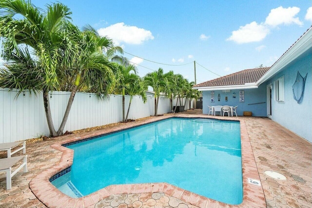 view of swimming pool featuring a patio, a fenced backyard, and a fenced in pool