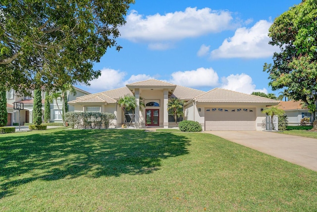 mediterranean / spanish-style home featuring stucco siding, french doors, a tile roof, and an attached garage