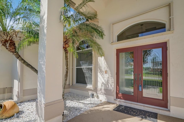 entrance to property with stucco siding and french doors