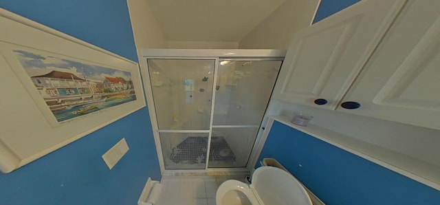 full bath featuring tile patterned floors, a stall shower, and toilet