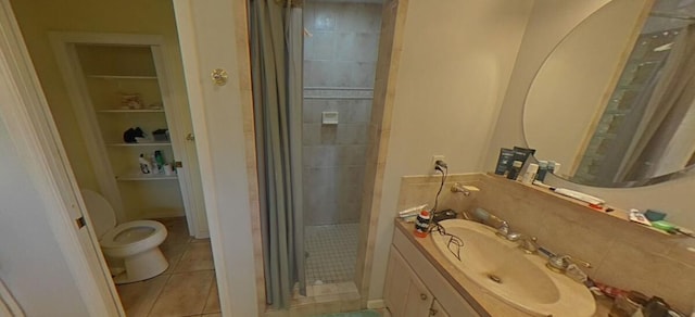 bathroom featuring tile patterned floors, toilet, a stall shower, and vanity