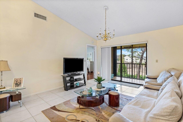 living area with tile patterned floors, visible vents, baseboards, and a chandelier