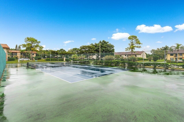 view of tennis court with fence