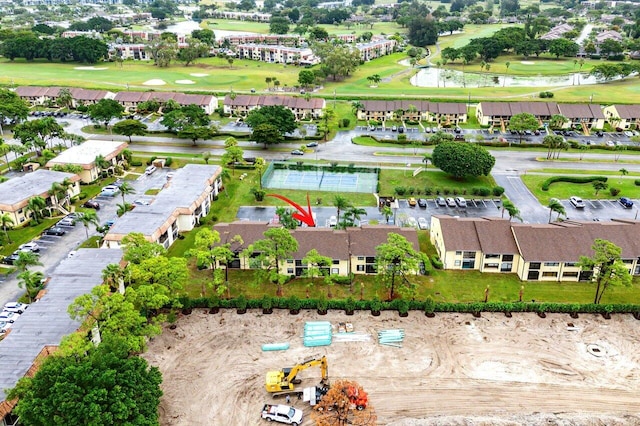 birds eye view of property featuring view of golf course and a residential view