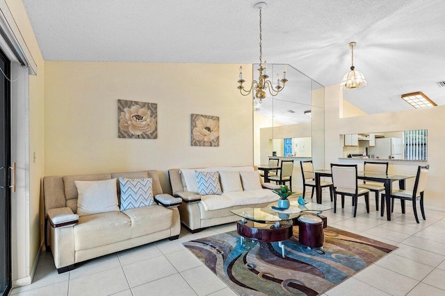 living room featuring visible vents, tile patterned flooring, vaulted ceiling, a textured ceiling, and a chandelier