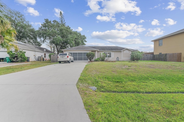 single story home with an attached garage, concrete driveway, a front yard, and fence