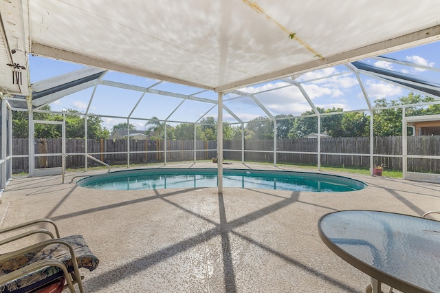 view of pool with a patio area, a fenced backyard, a fenced in pool, and a lanai