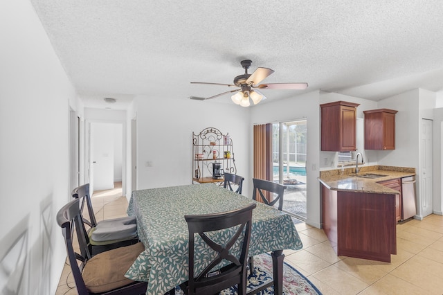 dining space with a textured ceiling, light tile patterned flooring, and ceiling fan