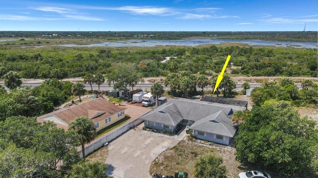 birds eye view of property featuring a view of trees