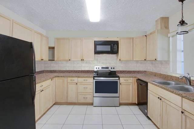 kitchen featuring a sink, black appliances, tasteful backsplash, and light brown cabinetry