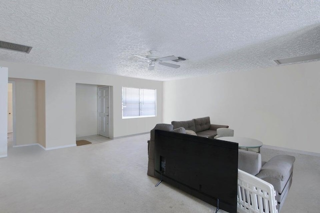 living area with a ceiling fan, carpet, visible vents, and baseboards