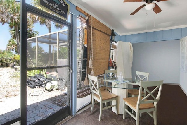 dining area featuring a ceiling fan and ornamental molding