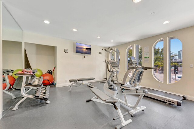 exercise room featuring recessed lighting and baseboards