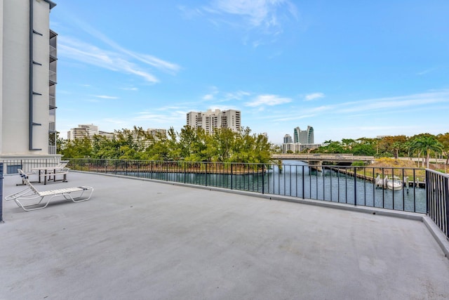 view of patio / terrace with a view of city and a water view