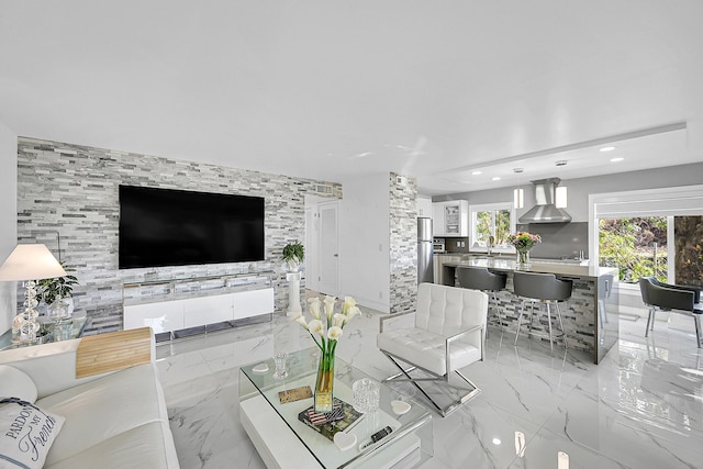 living room with recessed lighting and marble finish floor