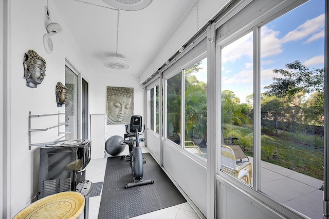 workout room with light tile patterned floors and a sunroom