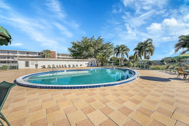 community pool with a patio area