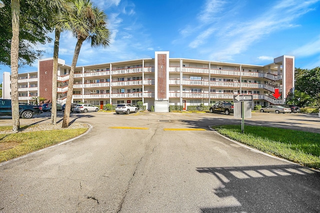 view of building exterior featuring uncovered parking