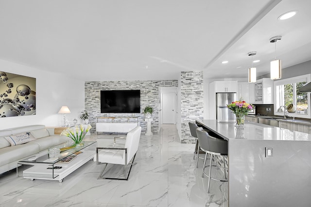 living room featuring recessed lighting and marble finish floor