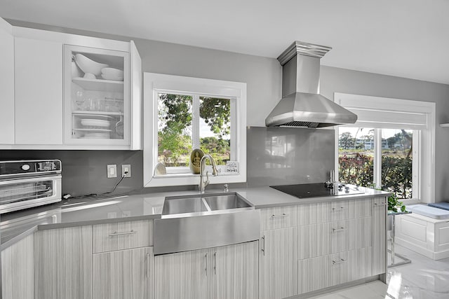 114 Greenbrier Unit C, West Palm Beach, FL 33417 - kitchen with glass insert cabinets, wall chimney range hood, light countertops, black electric cooktop, and a sink