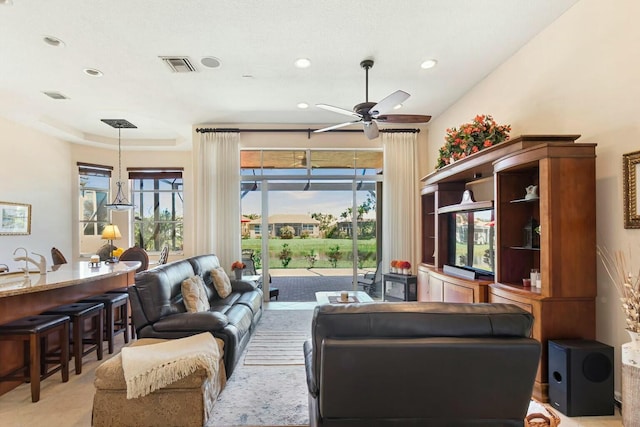 living room with recessed lighting, visible vents, and a ceiling fan