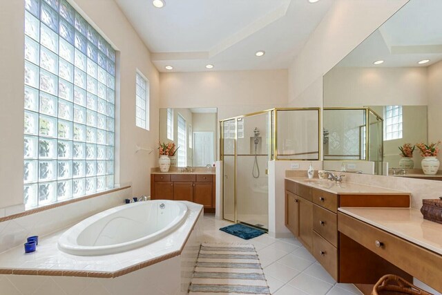 full bathroom featuring a garden tub, two vanities, recessed lighting, a shower stall, and tile patterned flooring