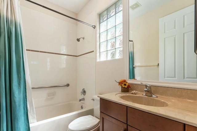 full bathroom featuring vanity, shower / tub combo, toilet, and visible vents