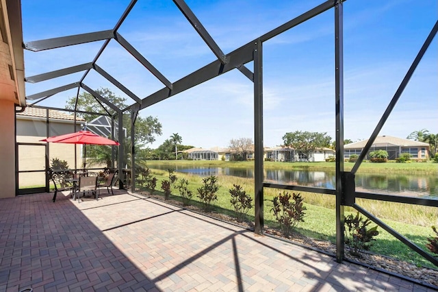 unfurnished sunroom featuring a water view