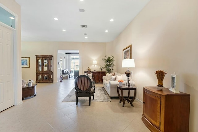 living area featuring recessed lighting, visible vents, baseboards, and light tile patterned floors