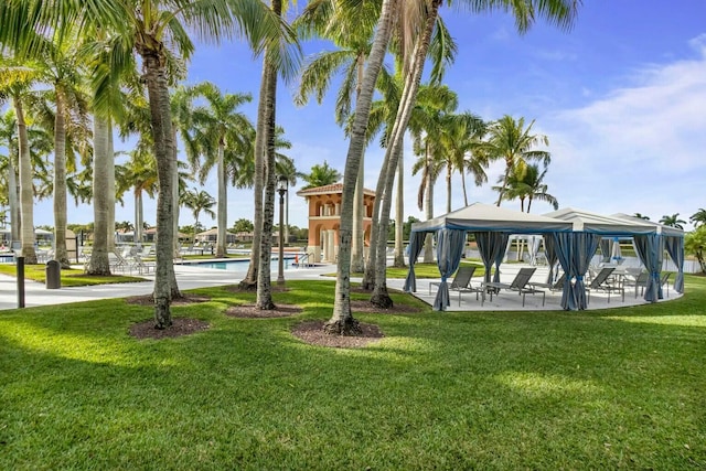 view of property's community featuring a gazebo, a swimming pool, and a lawn