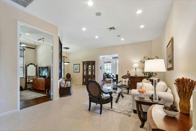 living room featuring recessed lighting, visible vents, baseboards, and light tile patterned floors