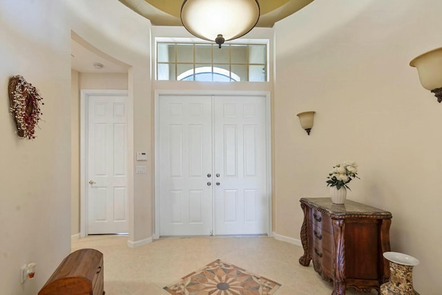 entryway featuring light tile patterned floors and baseboards