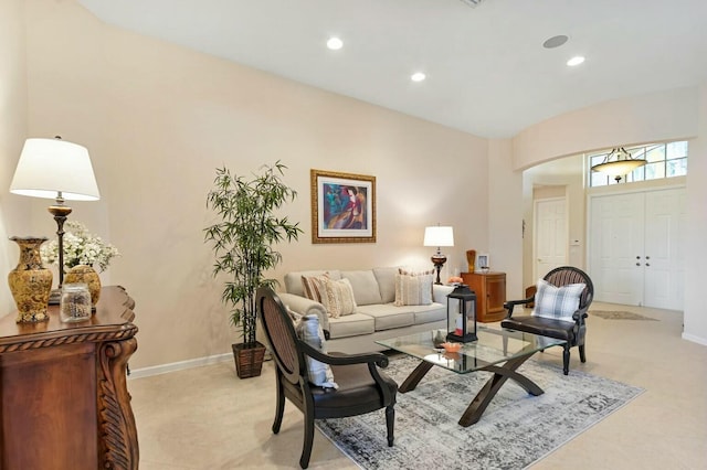 living room with recessed lighting, baseboards, and arched walkways