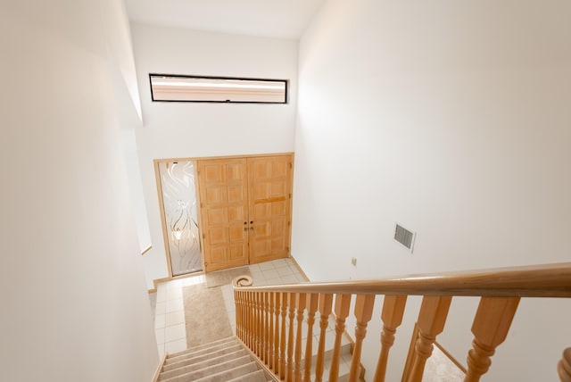 staircase with visible vents and tile patterned flooring