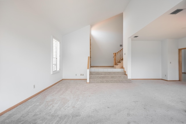 unfurnished living room featuring carpet flooring, visible vents, stairs, and baseboards