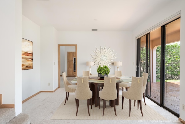 dining space featuring visible vents, baseboards, and carpet