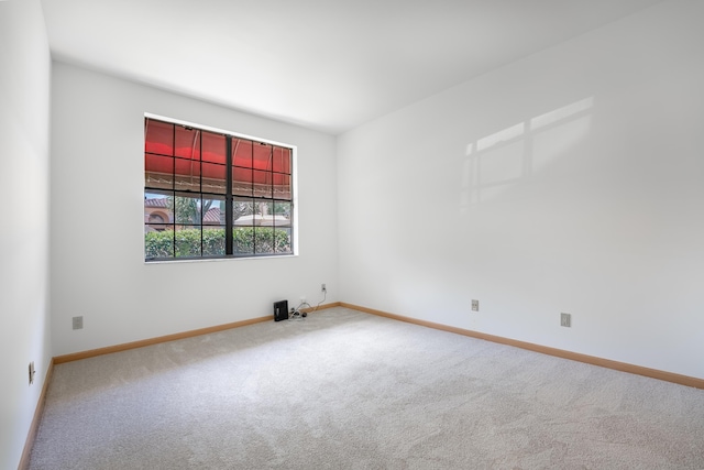 empty room with baseboards and carpet flooring